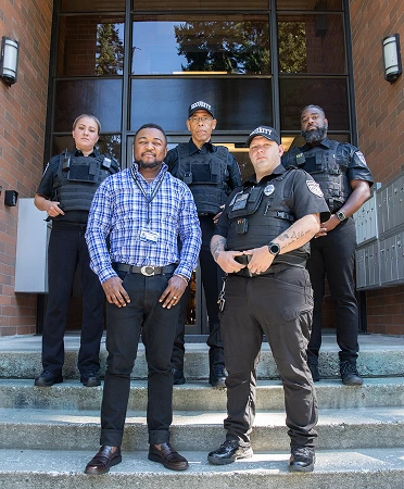 Construction security guards standing together at a jobsite entrance providing professional site protection services