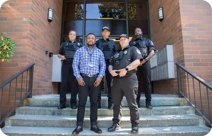 Construction security guards standing together at a jobsite entrance providing professional site protection services