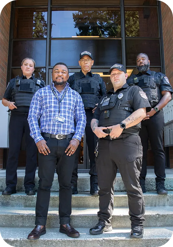 Construction security guards standing together at a jobsite entrance providing professional site protection services