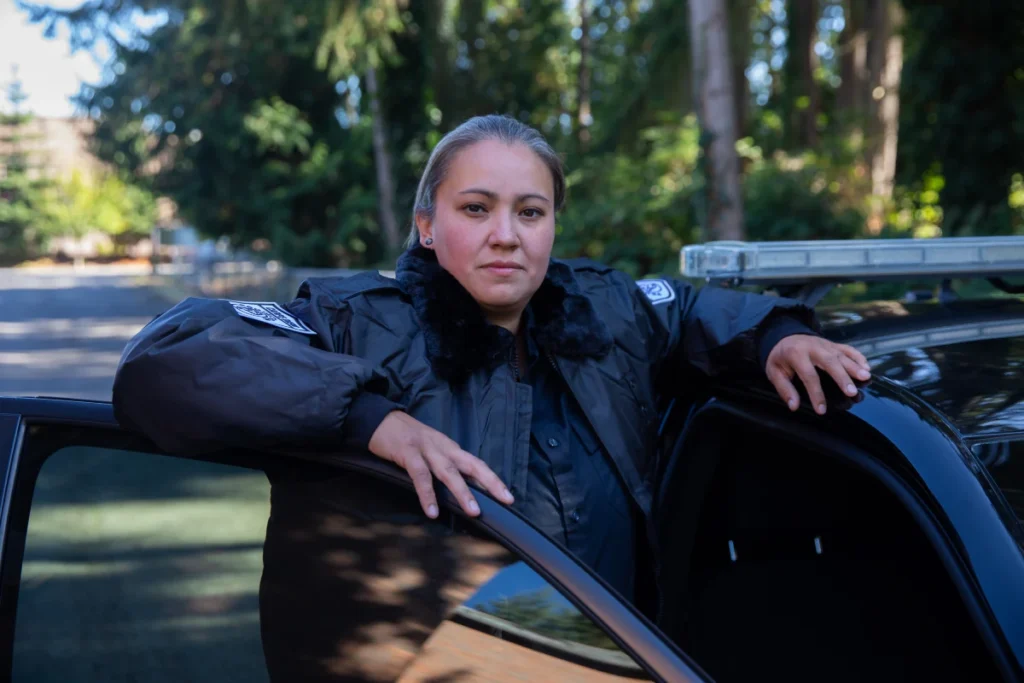 Carpe Diem Protection security officer standing beside a patrol vehicle